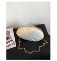 Close-up of shell-shaped pearl evening clutch with gold frame and detachable chain - White