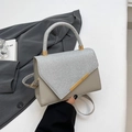 Borsa a mano grigio e argento glitter con barra in metallo dorato e manico tondo - Argento