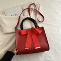 Red bridal crossbody bag with large bow decoration and black woven top handle - Red