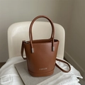 Minimalist brown leather bucket bag with top handle and crossbody strap for women - Tan
