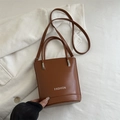 Brown bucket style tote bag in PU leather with white fashion lettering and top handles - Light Brown
