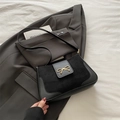 Elegant black underarm bag featuring suede patchwork and a gold bow buckle detail - Black