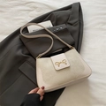 Cream minimalist crossbody bag with golden bow hardware and textured leather splicing - White