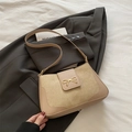 Beige minimalist crossbody bag with gold bow buckle on smooth leather texture - Khaki