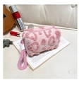Detailed texture of pink sherpa cosmetic bag featuring a heart pattern and soft handle - Light Pink