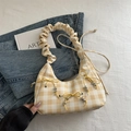 Yellow and white plaid hobo bag featuring decorative bows and ruffled cloud handle - Yellow