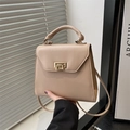 Chic beige crossbody bag with gold twist lock for women, shown in hand for scale - Khaki