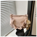 Pink ruffled tote bag with bear print and plush charm against a minimalist interior - With Pendant / Pink