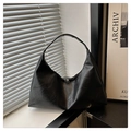 Detail of black vintage leather hobo bag with dual silver zippers in minimalist setting - Black