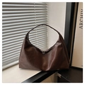 Detail view of large dark brown hobo shoulder bag with double zipper and leather texture - Brown