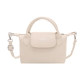 Minimalist beige PU leather dumpling bag with cylindrical handles and adjustable strap - White