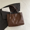 Dark brown leather tote bag with patchwork design and silver chain detail on a suit - Coffee without Pendant