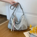 Futuristic silver metallic crescent tote bag with colorful woven rope charm detail - Silver with Charm