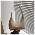 Detail view of glossy cream patent leather hobo bag with sleek zipper and shoulder strap - Khaki