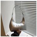 Detail of silver metallic hobo bag showing the glossy synthetic leather texture and finish - Silver