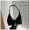 Detail shot of the glossy black patent leather finish on the minimalist shoulder bag - Black