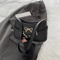Chic black PU leather underarm bag with a golden bow buckle and adjustable strap - Black