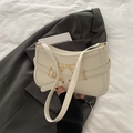 Chic beige underarm bag with gold bow ornament and adjustable shoulder strap for women - White