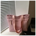 Macro detail of pink woven tote bag showing 3D wave texture and wide nylon straps - Pink