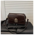 Detail of dark brown faux leather bag featuring a gold arch buckle and oil-wax texture - Coffee