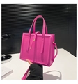 Detail of rose pink square handbag with glossy finish, dual handles, and golden hardware - Rose Pink