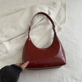 Deep red patent leather croissant shoulder bag with a glossy finish and half-moon shape - Red