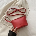 Chic red lychee leather bucket bag with embossed logo and adjustable shoulder strap - Red