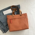 Orange-brown woven tote bag with front zipper pocket and brown nylon handles - Orange