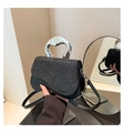 Detail of black saddle bag with glitter finish and irregular silver metal handle - Black