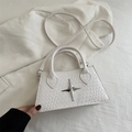 Close-up of white woven leather texture and silver star metal buckle on crossbody bag - White