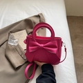 Rose pink handbag with large bow decoration and gold lettering on white bedding - Rose Pink