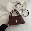 Minimalist burgundy woven crossbody bag with silver star emblem and thin shoulder strap - Red