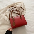Red lychee texture crossbody tote bag with brown handles and contrast stitch details - Red