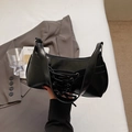 Chic black PU shoulder bag with unique criss-cross strap design for summer 2025 fashion - Black