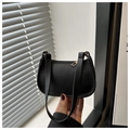 Close-up of black litchi grain leather baguette bag with premium golden zipper detail - Black