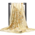 Detailed view of champagne silk scarf with yellow floral prints draped on a black metal frame - Champagne Floral Cluster (#12)