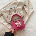 Mini rose red crossbody bag with silver metal bow and chain strap on fabric background - Rose Red