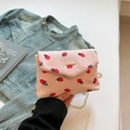 Pink corduroy crossbody bag with strawberry print and gold chain strap in hand - Strawberry Print Pink