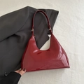 Detailed view of glossy wine red patent leather hobo bag with elegant gold hardware buckles - Patent Surface / Red (9287)
