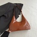 Macro detail of glossy brown patent leather on a vintage hobo shoulder bag - Patent Surface / Brown (9287)