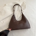 Dark brown woven leather hobo bag with gold buckle on white textured background - Dark Brown