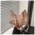 Detail of pink faux leather tote bag featuring a metal bow and FASHION logo - Pink