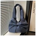 Detailed view of dark blue denim tote bag featuring large decorative bow and contrast stitching - Dark Blue