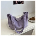 Detail of lavender corduroy hobo bag showing soft ribbed texture and adjustable strap - Purple