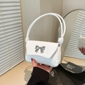 Chic white minimalist shoulder bag with a silver bow clasp and elegant rope handle - White