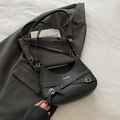 Black crescent shoulder bag featuring FASHION text print and decorative silver buckles - Black
