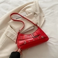 Y2K style red baguette shoulder bag featuring silver metal grommets and buckle details - Red