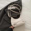 Minimalist cream white crescent shoulder bag with silver buckles and decorative straps - White