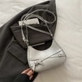Silver crescent underarm bag with decorative straps and metallic finish - Silver