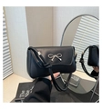 Detail of silver bow metal ornament on a premium black leather shoulder bag - Black